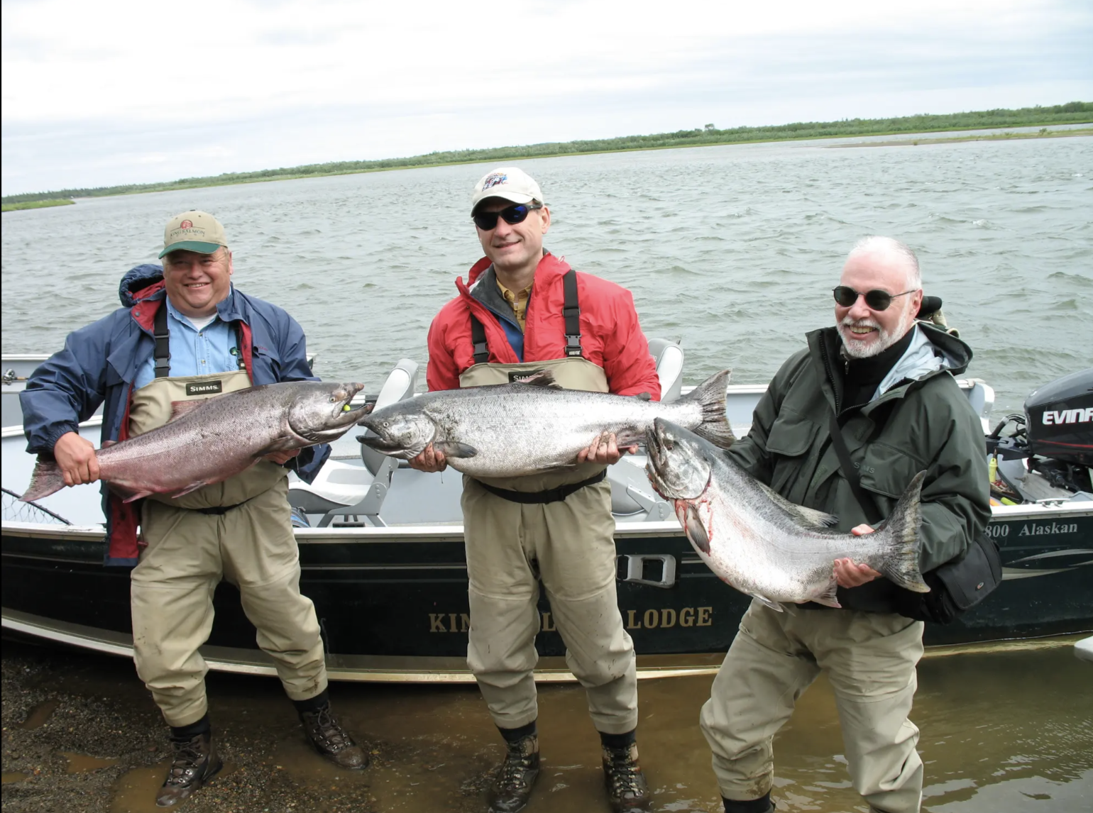 Supreme Court Justice Samuel Alito, center, and hedge fund billionaire Paul Singer, right, hold king salmon with another guest (via Propublica)